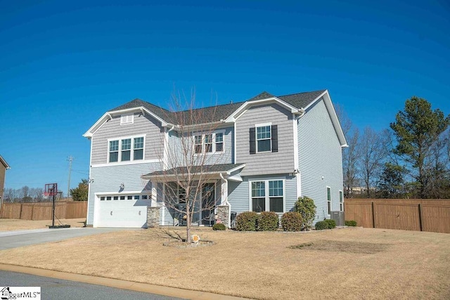 craftsman-style house with driveway, an attached garage, fence, and cooling unit