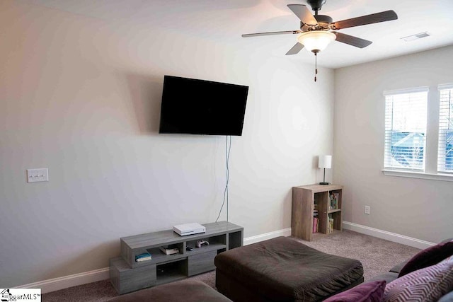 living room featuring baseboards, carpet, visible vents, and a ceiling fan