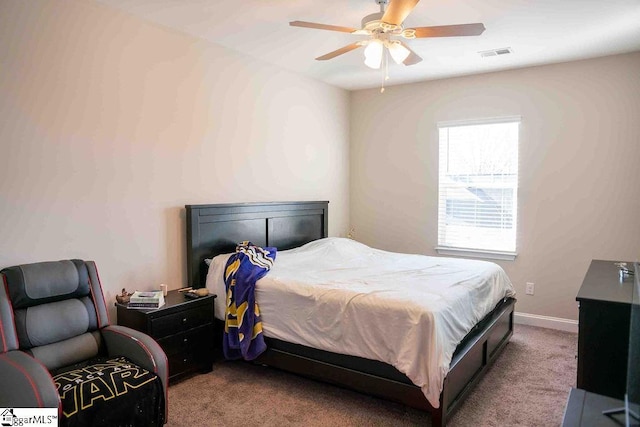 carpeted bedroom with a ceiling fan, visible vents, and baseboards