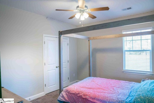 bedroom featuring a ceiling fan, baseboards, visible vents, and carpet flooring