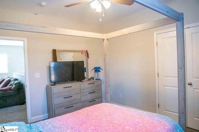 bedroom featuring a ceiling fan, carpet, and baseboards