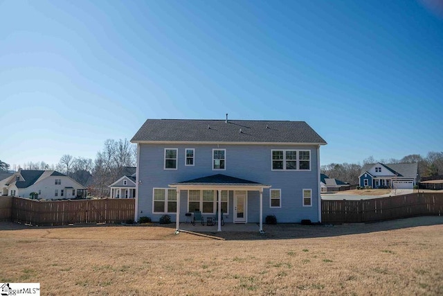 back of house featuring a patio area, a fenced backyard, and a lawn