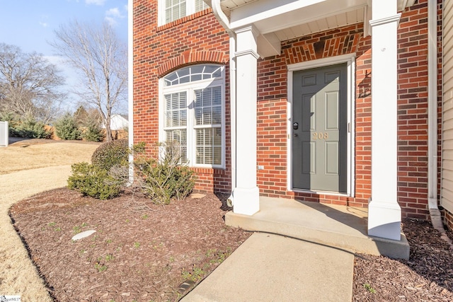 property entrance featuring brick siding