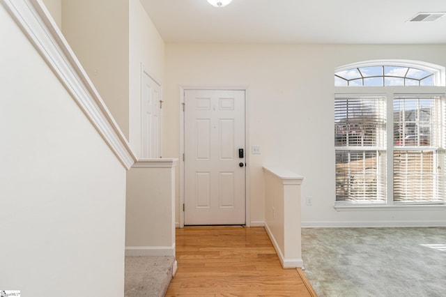 entryway featuring baseboards, visible vents, and light wood-style floors