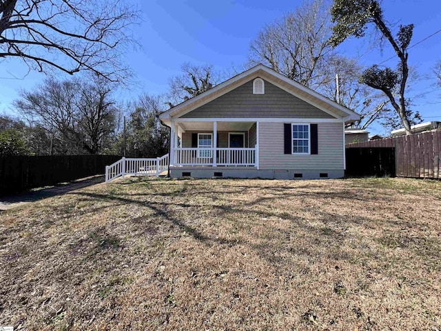 view of front of property featuring covered porch, a front lawn, crawl space, and fence private yard