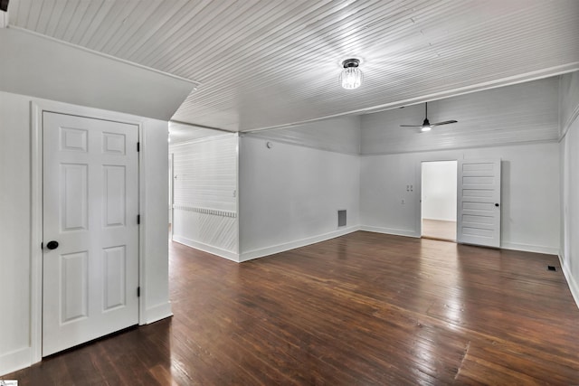 additional living space featuring a ceiling fan, lofted ceiling, dark wood finished floors, and baseboards