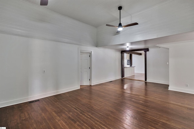 spare room featuring ceiling fan, dark wood-type flooring, visible vents, and baseboards