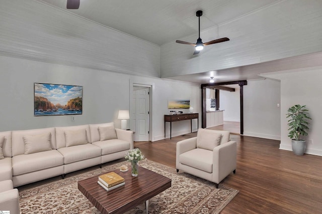 living area featuring baseboards, a ceiling fan, and dark wood-style flooring