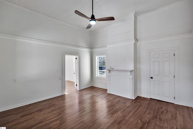 spare room with lofted ceiling, dark wood finished floors, a ceiling fan, and baseboards