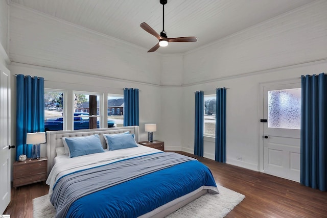 bedroom featuring multiple windows, dark wood finished floors, and baseboards