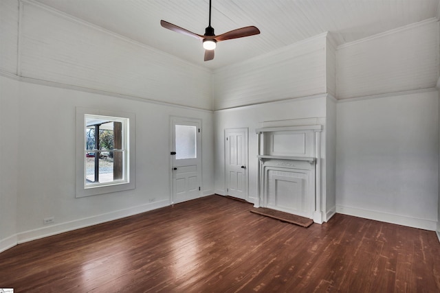 empty room with ornamental molding, dark wood finished floors, and baseboards