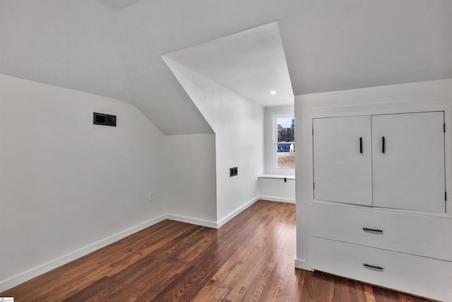 bonus room with lofted ceiling, dark wood finished floors, visible vents, and baseboards