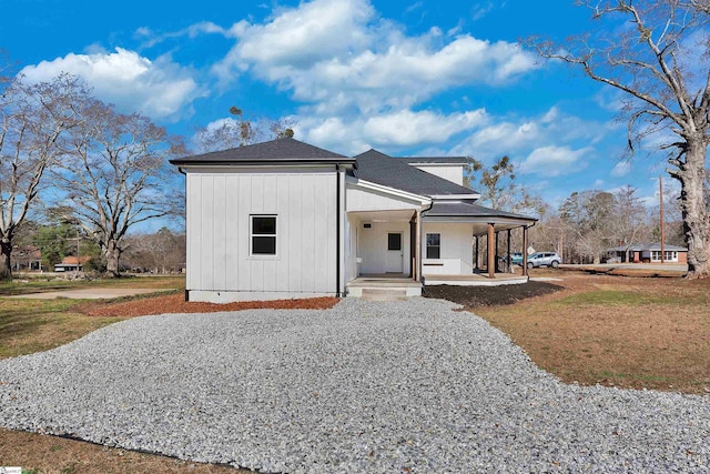 view of front of property with a porch, board and batten siding, and a front yard