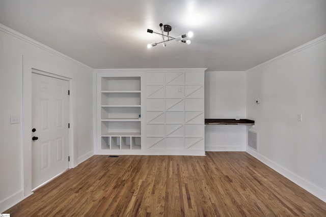 unfurnished living room featuring ornamental molding, built in shelves, wood finished floors, and visible vents