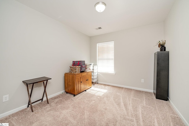 miscellaneous room featuring light carpet, visible vents, and baseboards