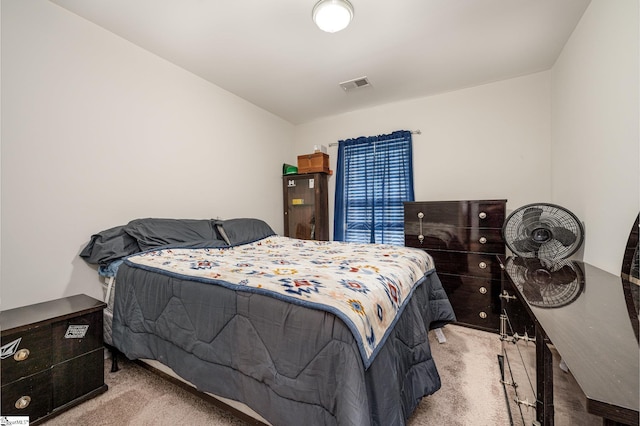 bedroom featuring light carpet and visible vents