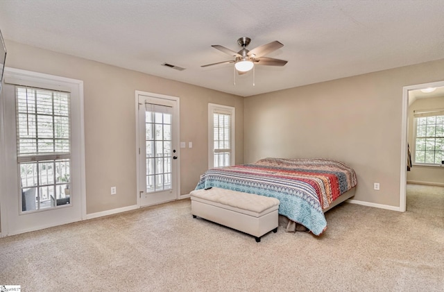 bedroom with visible vents, baseboards, access to outside, a textured ceiling, and carpet floors