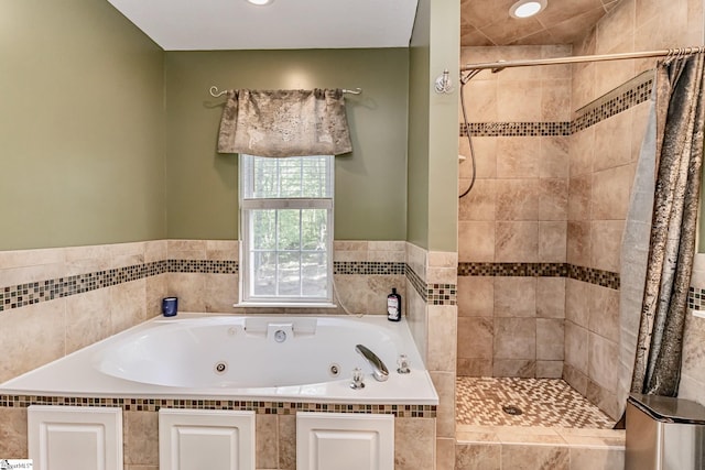 full bathroom featuring a whirlpool tub, a shower stall, and recessed lighting