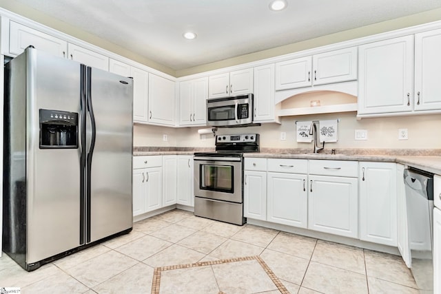 kitchen featuring light tile patterned flooring, stainless steel appliances, light countertops, white cabinetry, and recessed lighting