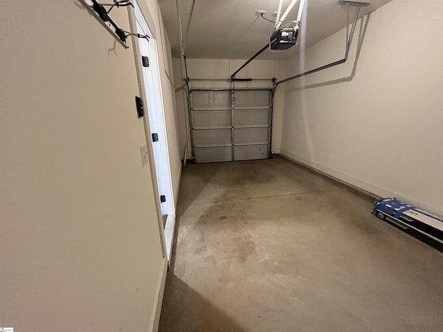 garage featuring baseboards and a garage door opener