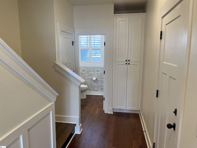 hall with stairs, dark wood finished floors, and baseboards