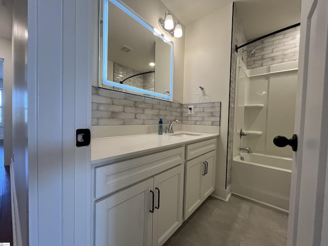 full bathroom featuring shower / washtub combination, visible vents, decorative backsplash, vanity, and tile patterned floors