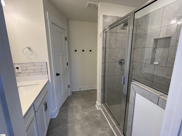 full bathroom featuring a stall shower, visible vents, vanity, and baseboards