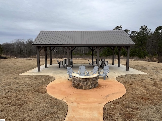 view of home's community featuring a yard, a gazebo, an outdoor fire pit, and a patio area