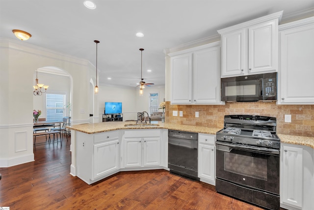 kitchen with black appliances, a peninsula, and white cabinetry