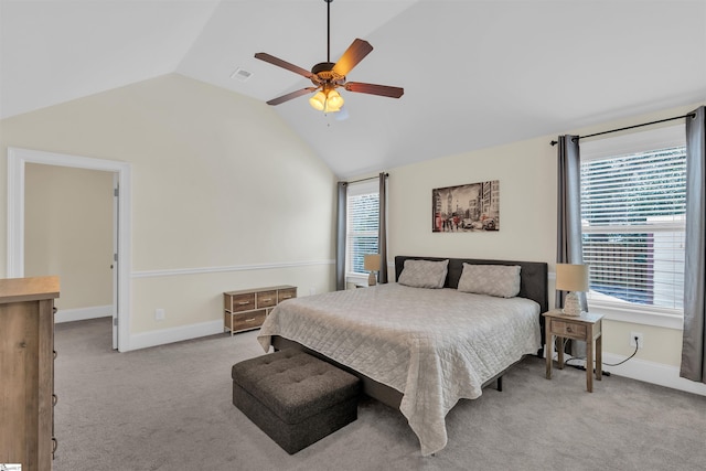 bedroom featuring lofted ceiling, ceiling fan, baseboards, and light colored carpet