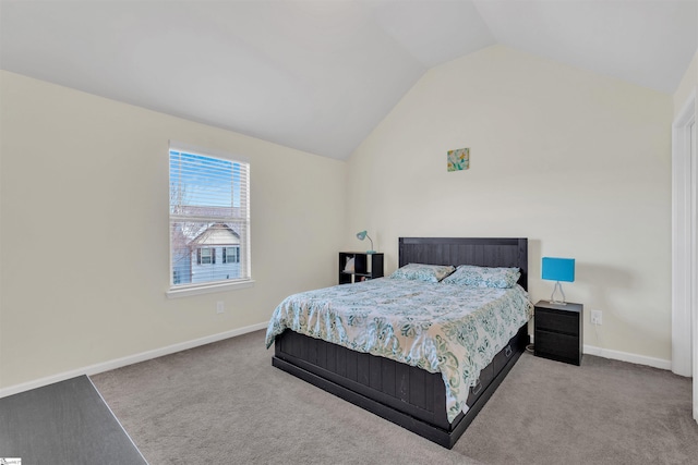 bedroom featuring lofted ceiling, light colored carpet, and baseboards