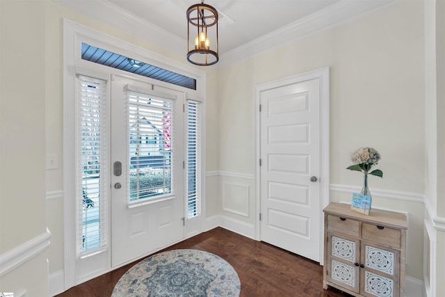 foyer entrance with crown molding, a chandelier, and dark wood-style flooring