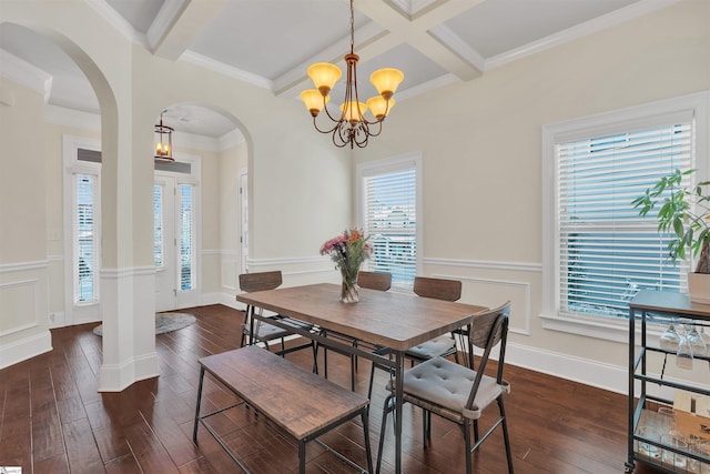 dining space with arched walkways, coffered ceiling, dark wood-style flooring, an inviting chandelier, and beam ceiling