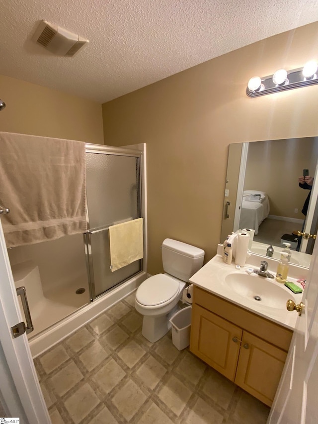 bathroom featuring a stall shower, visible vents, vanity, and tile patterned floors