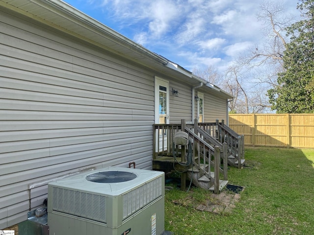 exterior space with central air condition unit and fence