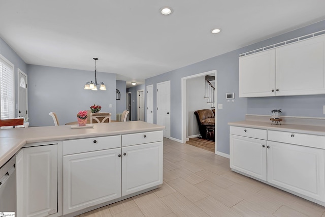 kitchen with hanging light fixtures, white cabinetry, and light countertops