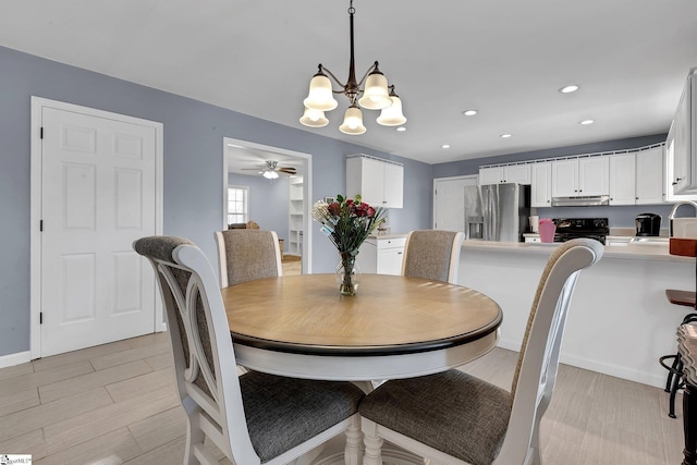 dining room with baseboards, ceiling fan with notable chandelier, and recessed lighting