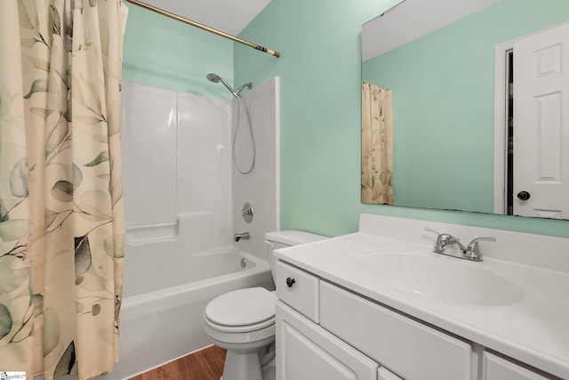 full bath featuring toilet, shower / tub combo, wood finished floors, and vanity