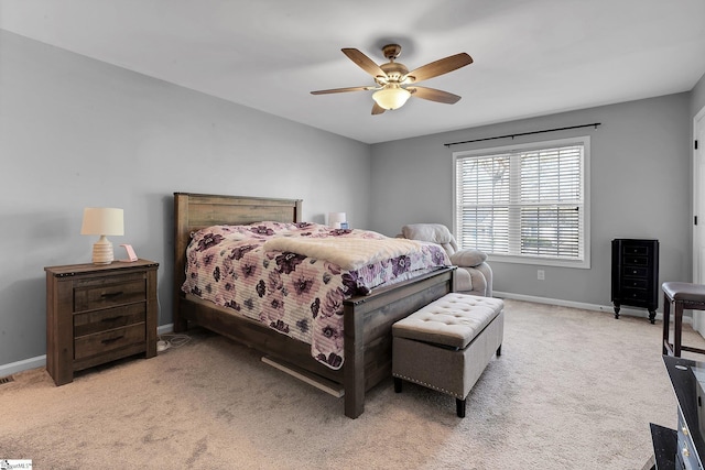 bedroom featuring baseboards, a ceiling fan, and light colored carpet