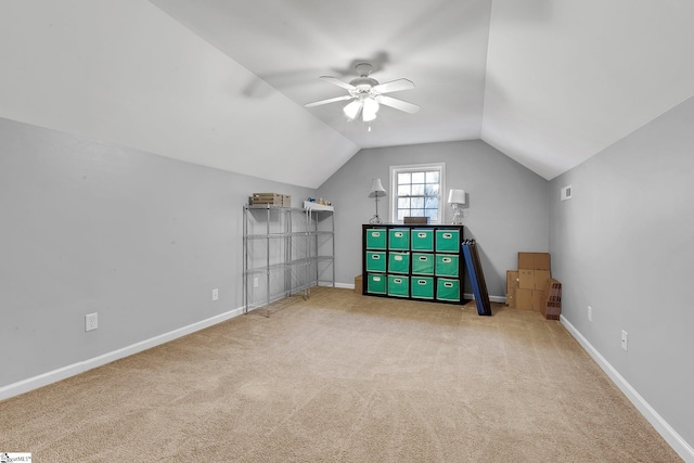 bonus room featuring vaulted ceiling, light carpet, a ceiling fan, and baseboards