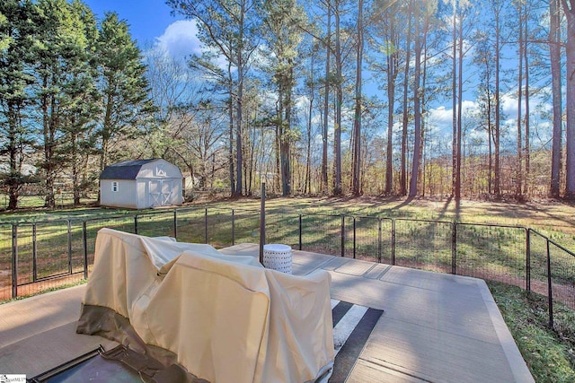 view of patio with an outbuilding and a storage unit