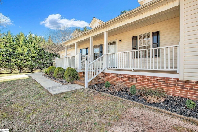 doorway to property featuring crawl space and a porch