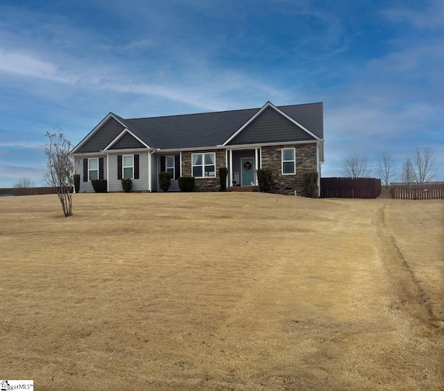 view of front of property with a front yard and fence