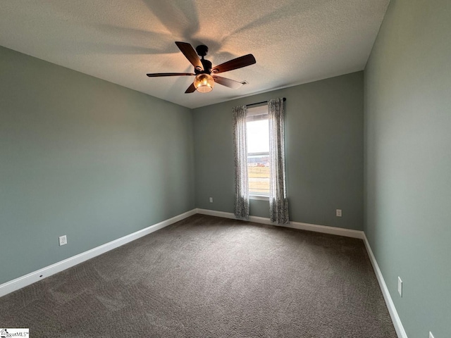 carpeted spare room with a textured ceiling, a ceiling fan, and baseboards