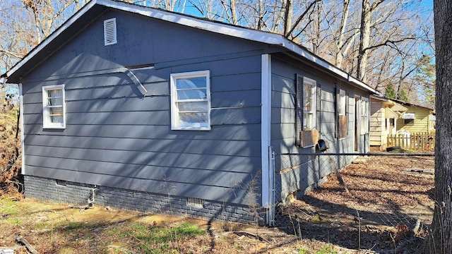 view of property exterior with crawl space and fence