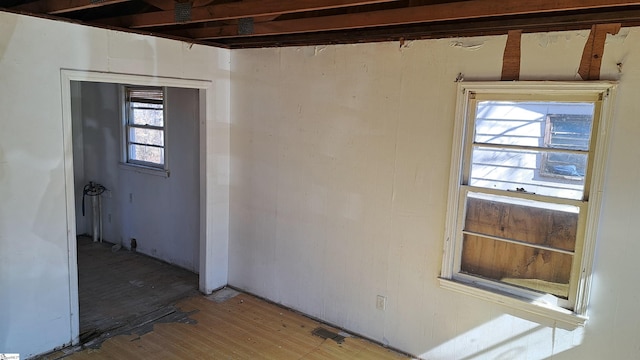 empty room featuring wood finished floors and visible vents