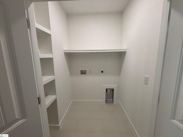 laundry area featuring light tile patterned floors, laundry area, washer hookup, baseboards, and electric dryer hookup