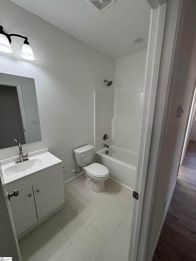 full bath with visible vents, toilet, vanity, shower / tub combination, and wood finished floors