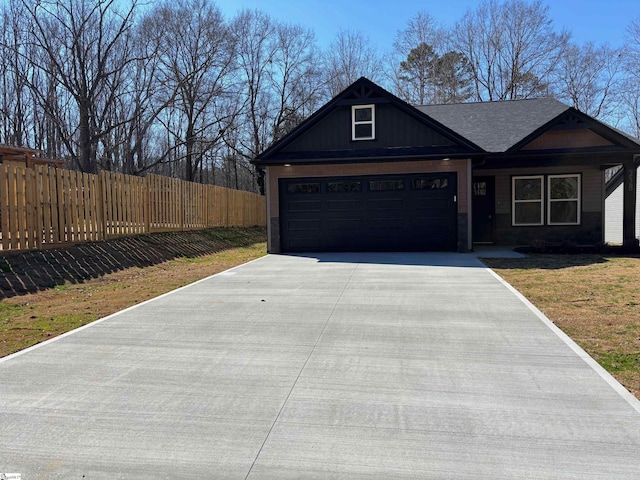 view of front of property with driveway, fence, and a front lawn