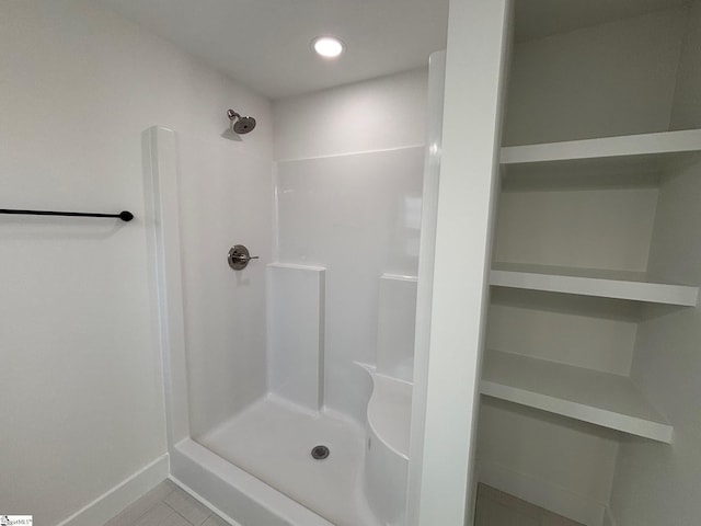 full bathroom featuring baseboards, a shower stall, and recessed lighting